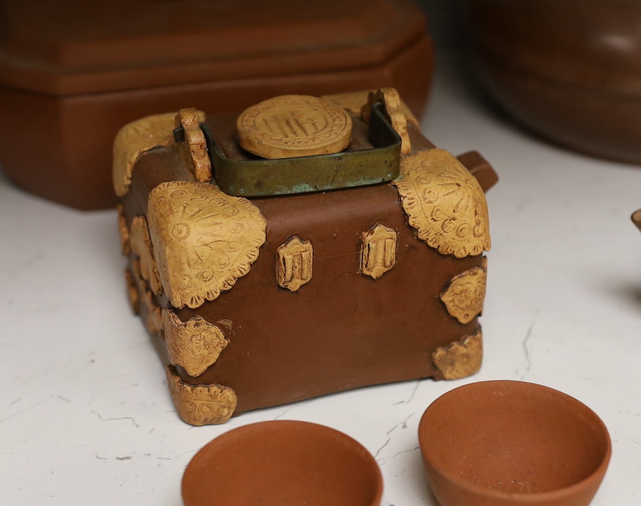 A Chinese Yixing pottery teapot, two boxes and covers and teawares